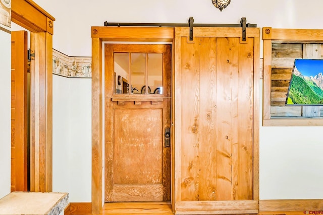 interior details with hardwood / wood-style flooring and a barn door