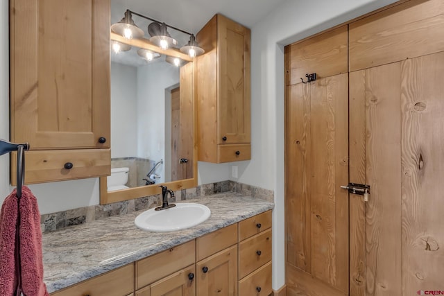 bathroom with vanity and toilet