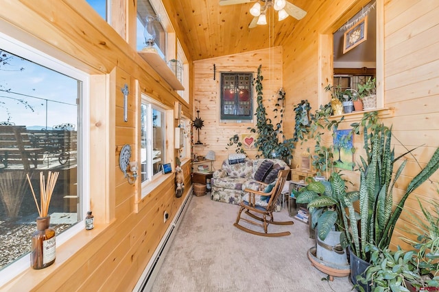 living area featuring wooden walls, wooden ceiling, ceiling fan, and carpet flooring