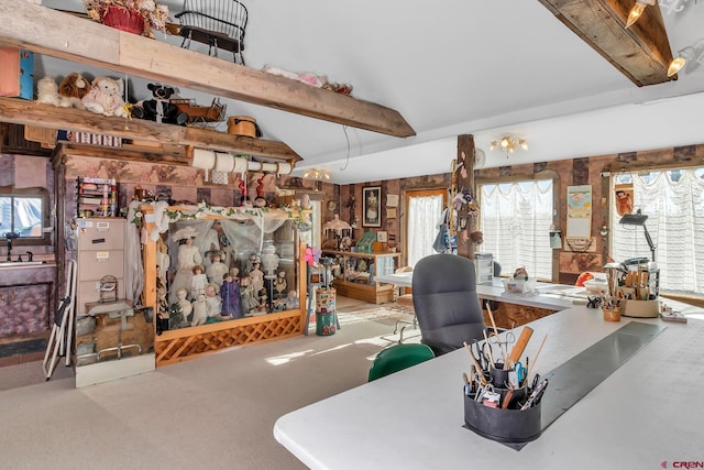 carpeted living room with beam ceiling and a wealth of natural light