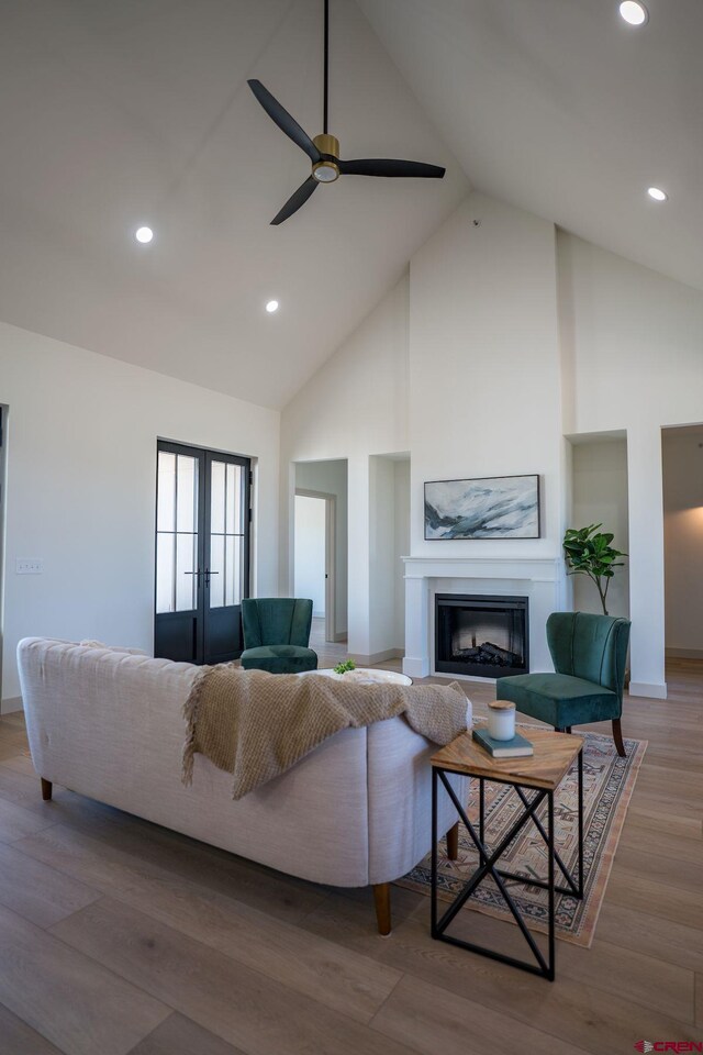 living room with high vaulted ceiling, french doors, hardwood / wood-style floors, and ceiling fan