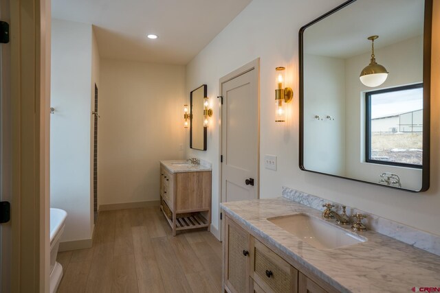 bathroom featuring hardwood / wood-style floors, vanity, and a bathtub