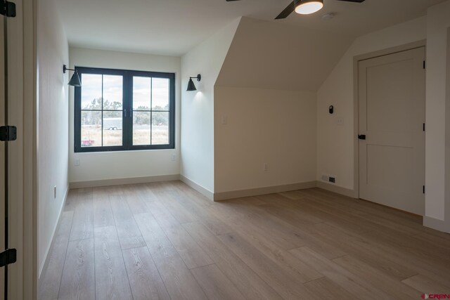 bonus room with light hardwood / wood-style flooring, ceiling fan, and vaulted ceiling