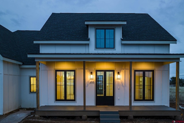 back of property with covered porch