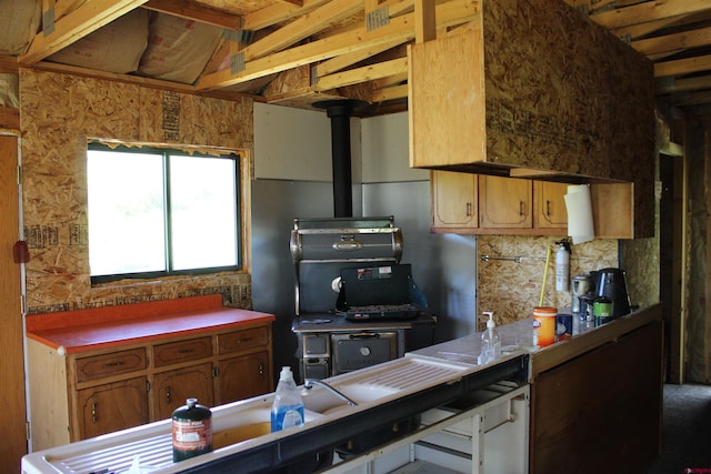 kitchen featuring a wood stove and decorative backsplash