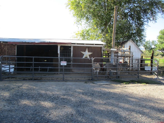 view of horse barn with an outdoor structure