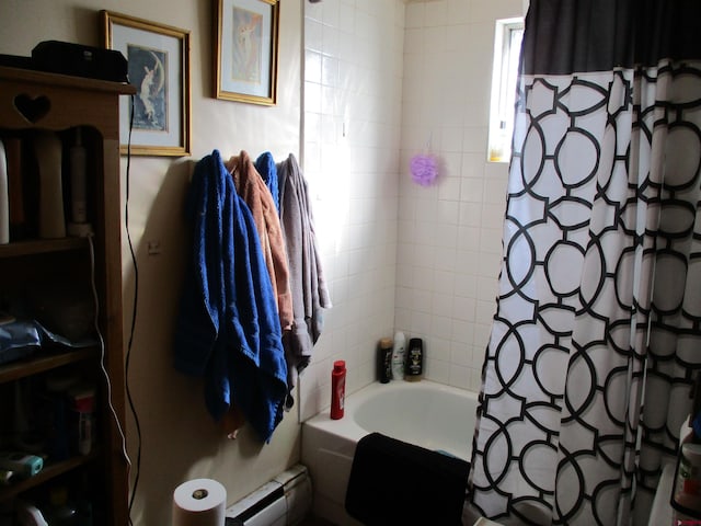 bathroom featuring shower / tub combo and baseboard heating