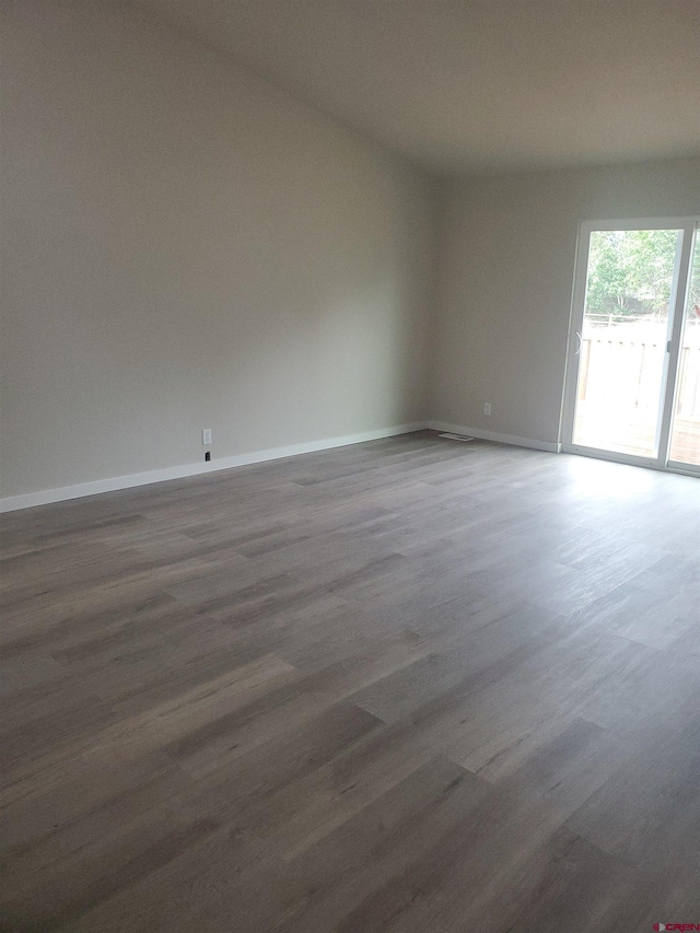 spare room featuring dark hardwood / wood-style floors