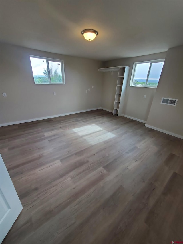 unfurnished bedroom featuring a closet and dark wood-type flooring