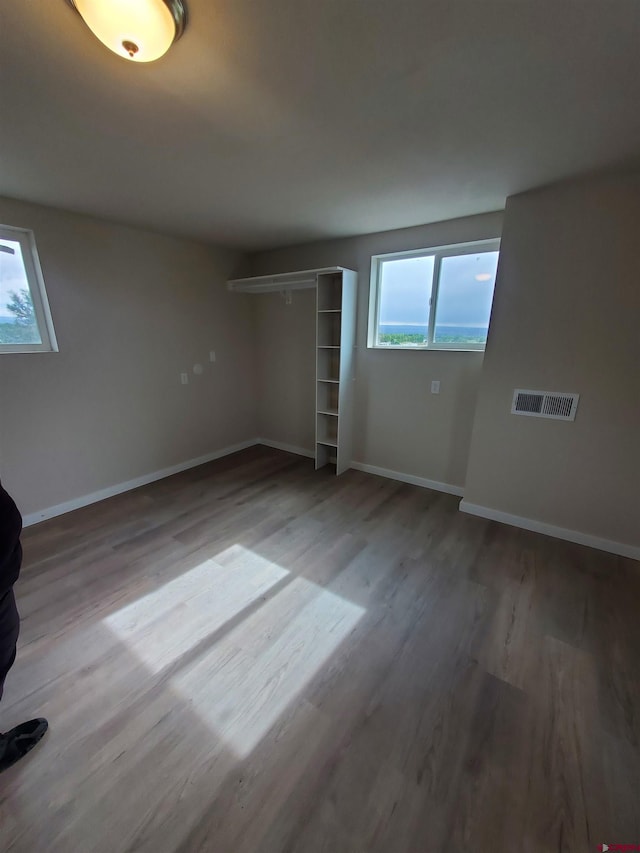 unfurnished bedroom featuring a closet and dark hardwood / wood-style floors