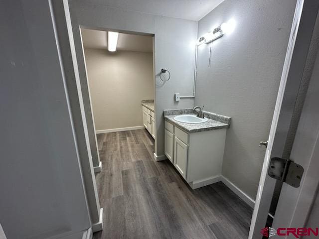 bathroom featuring vanity and wood-type flooring