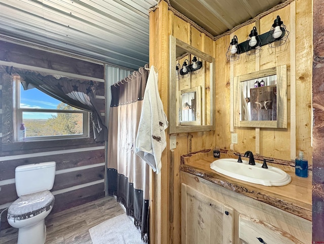 bathroom featuring wood ceiling, vanity, hardwood / wood-style flooring, wooden walls, and toilet