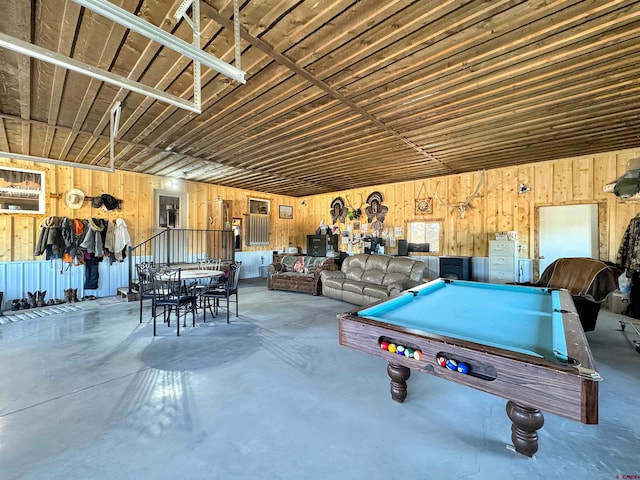 game room featuring pool table, wooden walls, and concrete floors