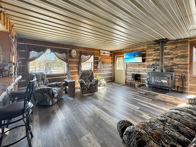 living room with a wood stove, wood walls, hardwood / wood-style flooring, and wooden ceiling