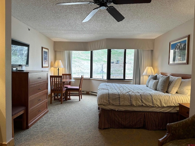 bedroom featuring ceiling fan, carpet, a textured ceiling, and a baseboard radiator