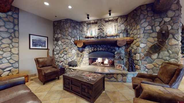 living room with a stone fireplace and light tile patterned flooring