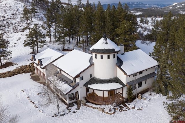 snowy aerial view featuring a mountain view