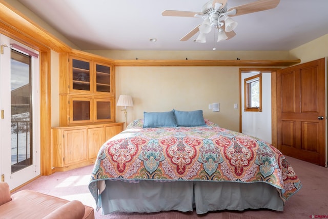 carpeted bedroom featuring access to outside and ceiling fan