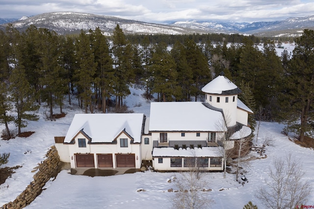 snowy aerial view with a mountain view