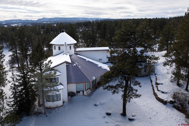 snowy aerial view featuring a mountain view