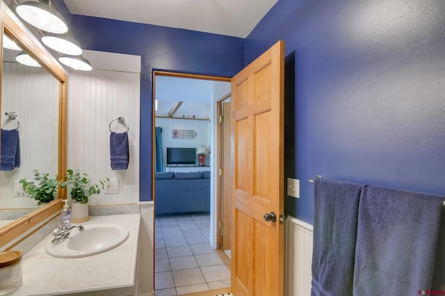 bathroom featuring vanity with extensive cabinet space and tile flooring