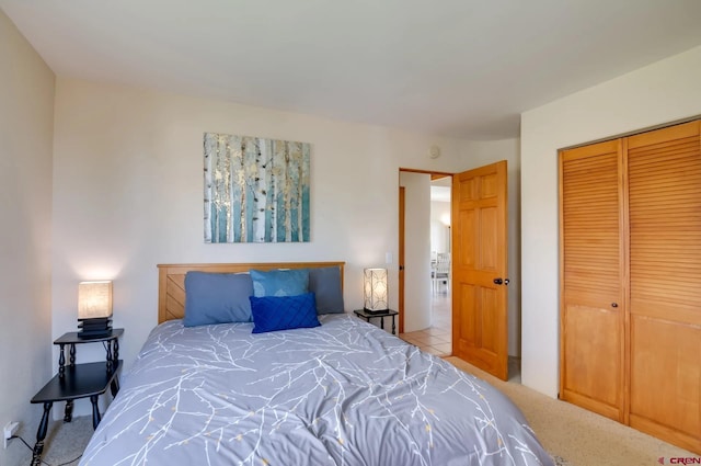 bedroom with light carpet and a closet