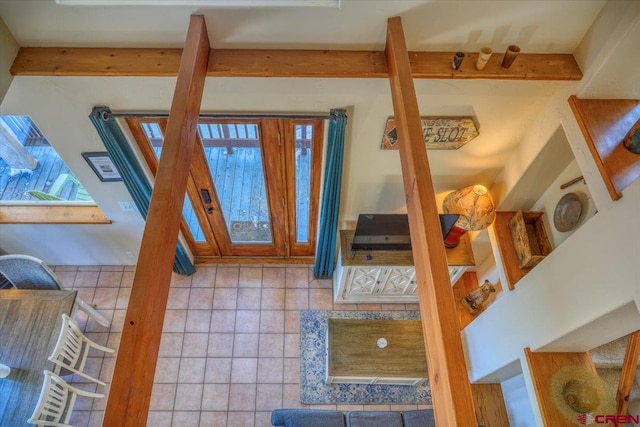 tiled entryway with beamed ceiling