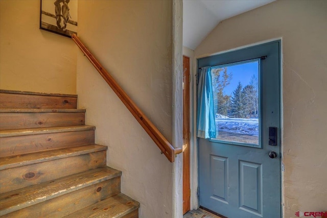 staircase with vaulted ceiling