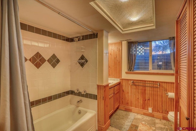 bathroom with tile flooring, crown molding, a tray ceiling, and toilet