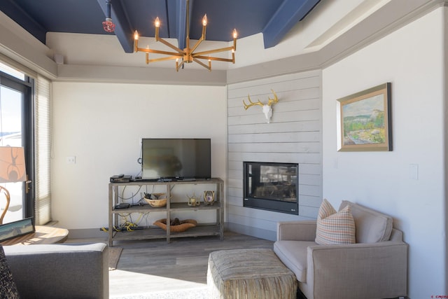 living room featuring hardwood / wood-style flooring, a fireplace, and an inviting chandelier