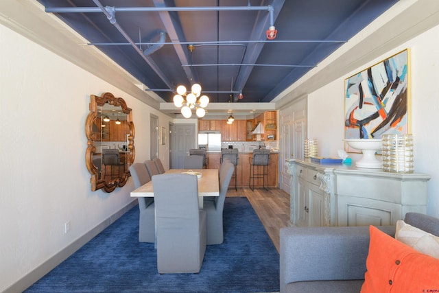 dining area featuring dark hardwood / wood-style floors and a notable chandelier