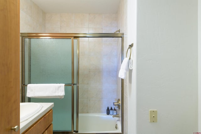 bathroom with shower / bath combination with glass door and vanity