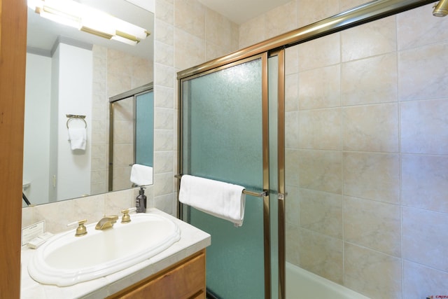 bathroom with vanity and combined bath / shower with glass door