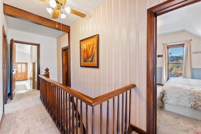 corridor with light colored carpet and lofted ceiling