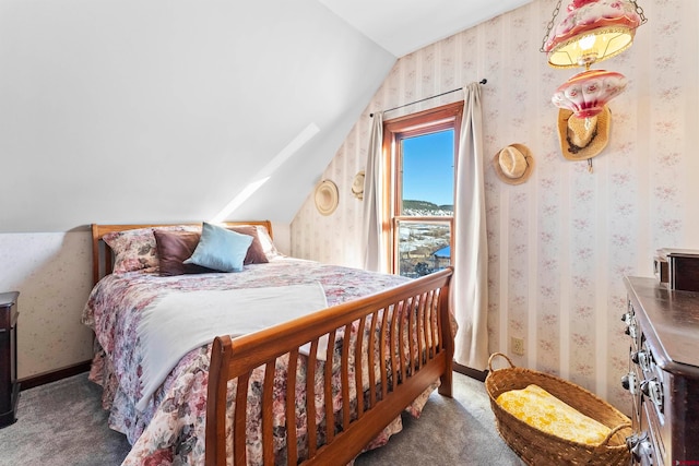 bedroom with vaulted ceiling and dark colored carpet