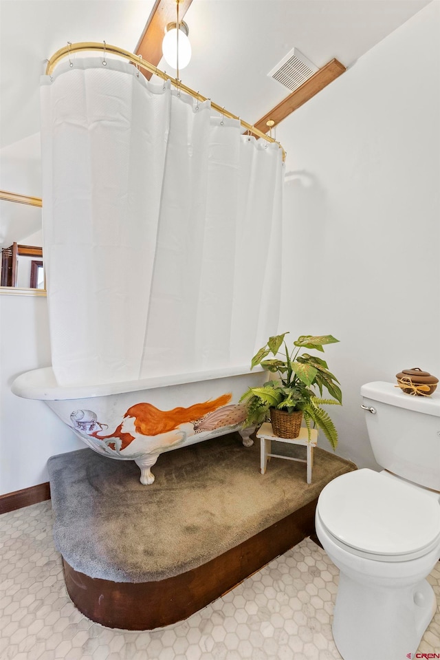 bathroom featuring toilet and tile flooring