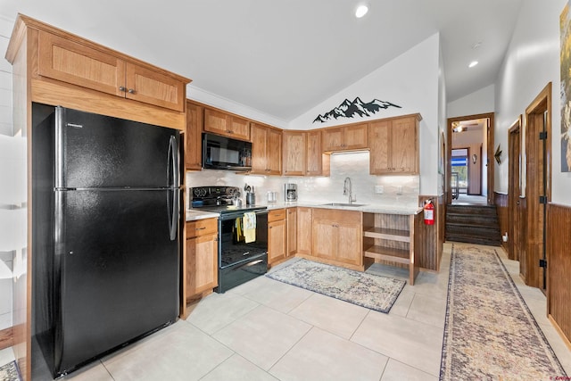 kitchen featuring light tile floors, black appliances, backsplash, lofted ceiling, and sink