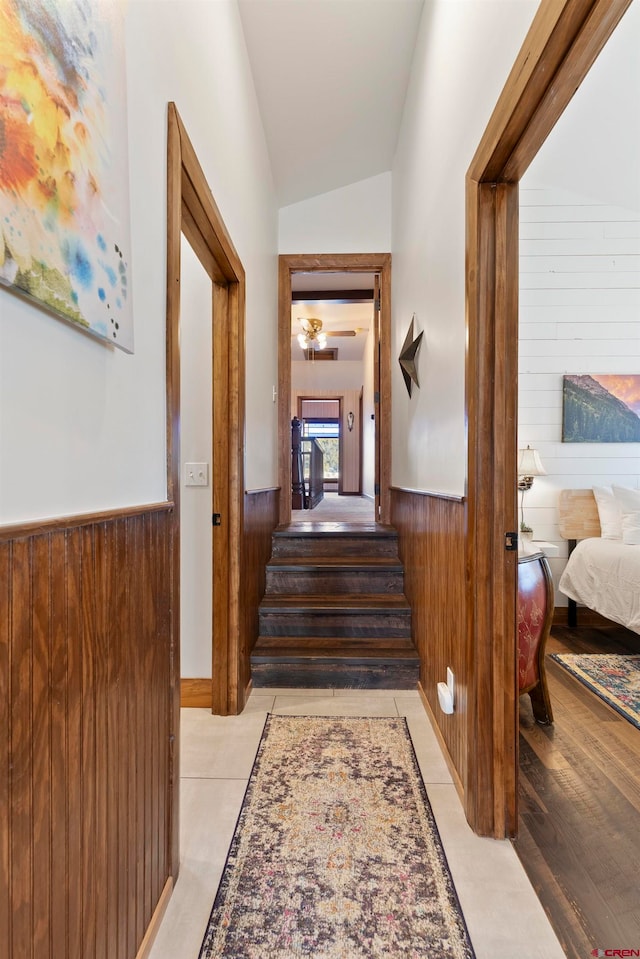 hall with lofted ceiling, a chandelier, and light hardwood / wood-style floors