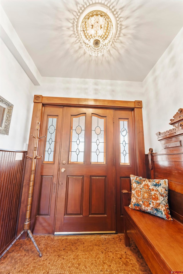 foyer featuring dark colored carpet