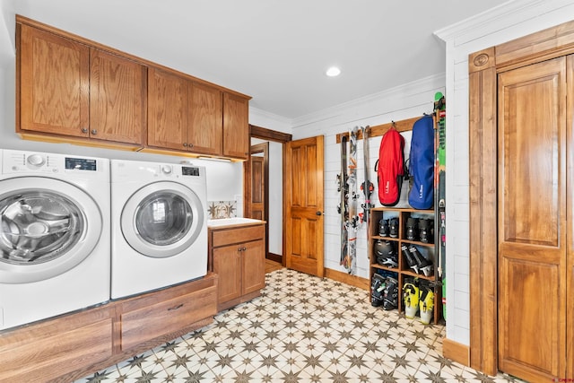 laundry area with cabinets, sink, light tile floors, crown molding, and independent washer and dryer