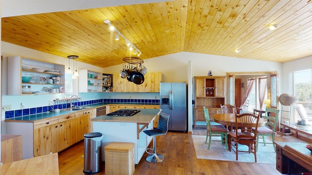 kitchen featuring sink, light hardwood / wood-style floors, wooden ceiling, and stainless steel appliances