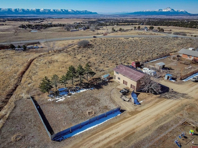 drone / aerial view featuring a mountain view and a rural view