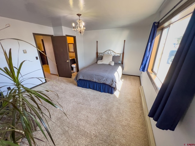 carpeted bedroom with connected bathroom and a chandelier