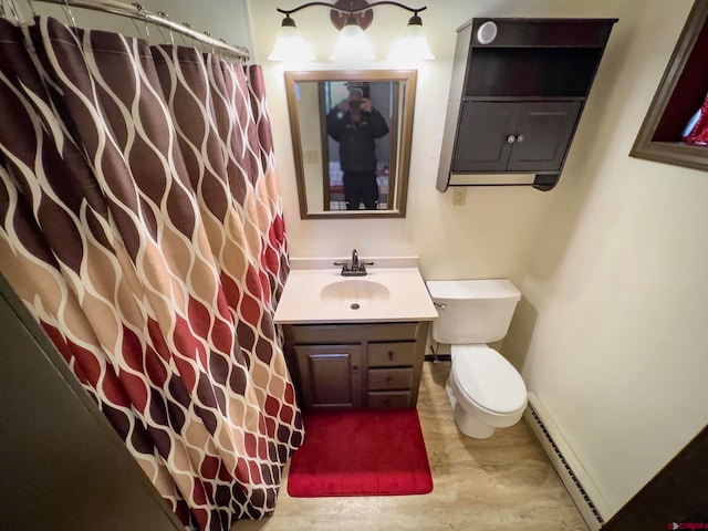 bathroom featuring toilet, vanity, a baseboard heating unit, and wood-type flooring