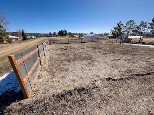 view of yard with a rural view and a storage shed