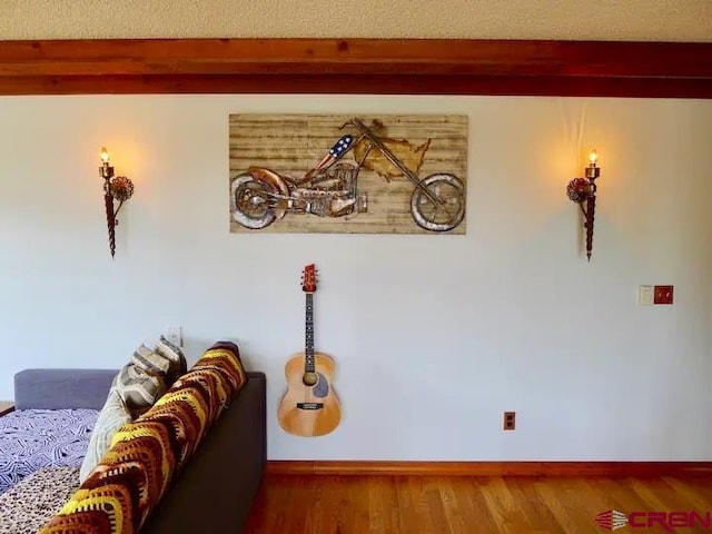 interior space with a textured ceiling and wood-type flooring