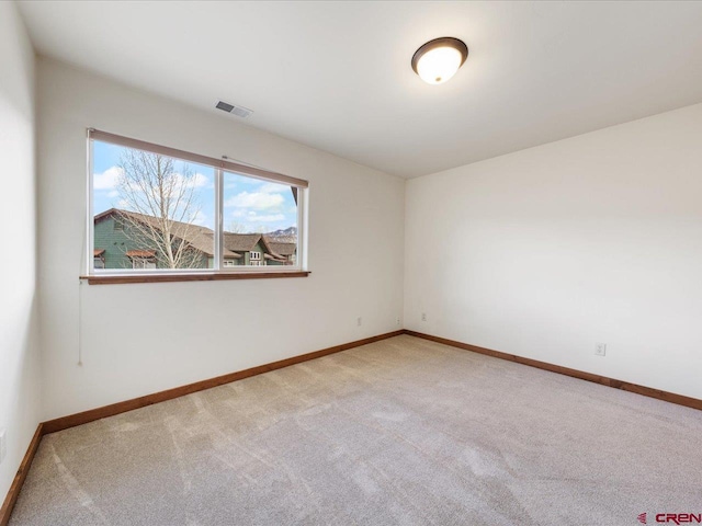 unfurnished room with light colored carpet