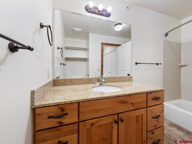 bathroom featuring bathing tub / shower combination and vanity