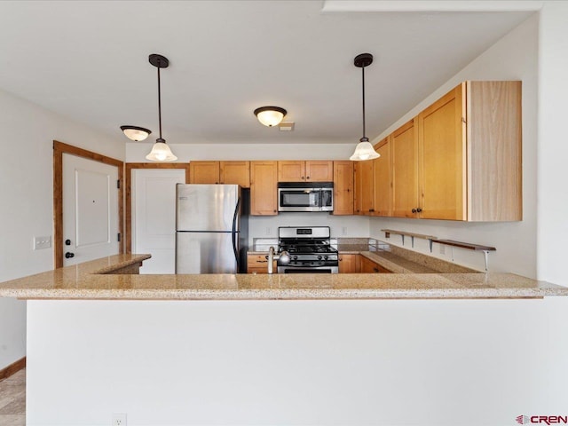 kitchen featuring appliances with stainless steel finishes, pendant lighting, light stone countertops, and kitchen peninsula