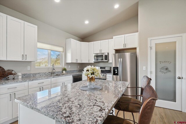 kitchen with white cabinetry, sink, a center island, and stainless steel appliances